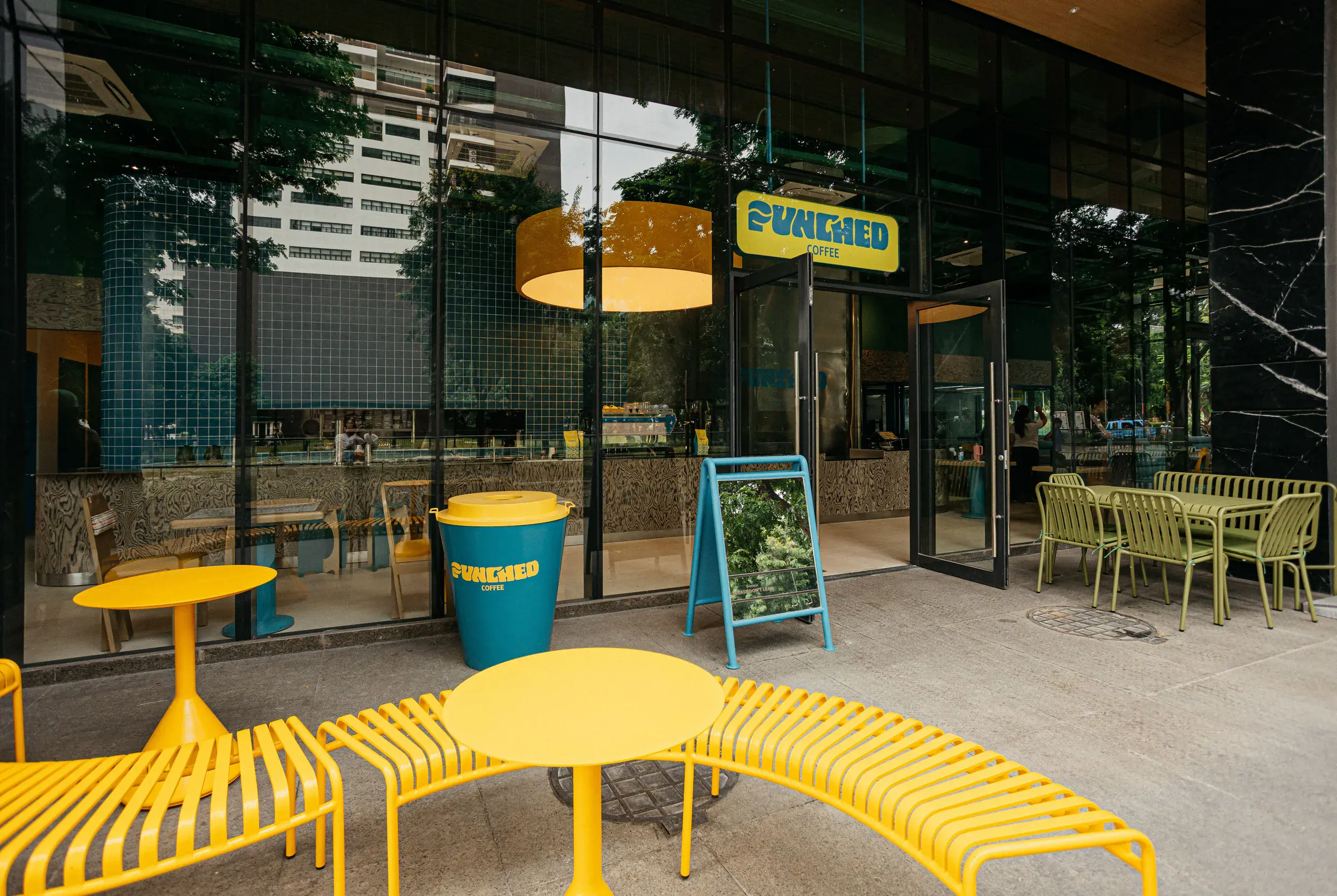 Yellow benches and tables outside the Johndorf Tower café
