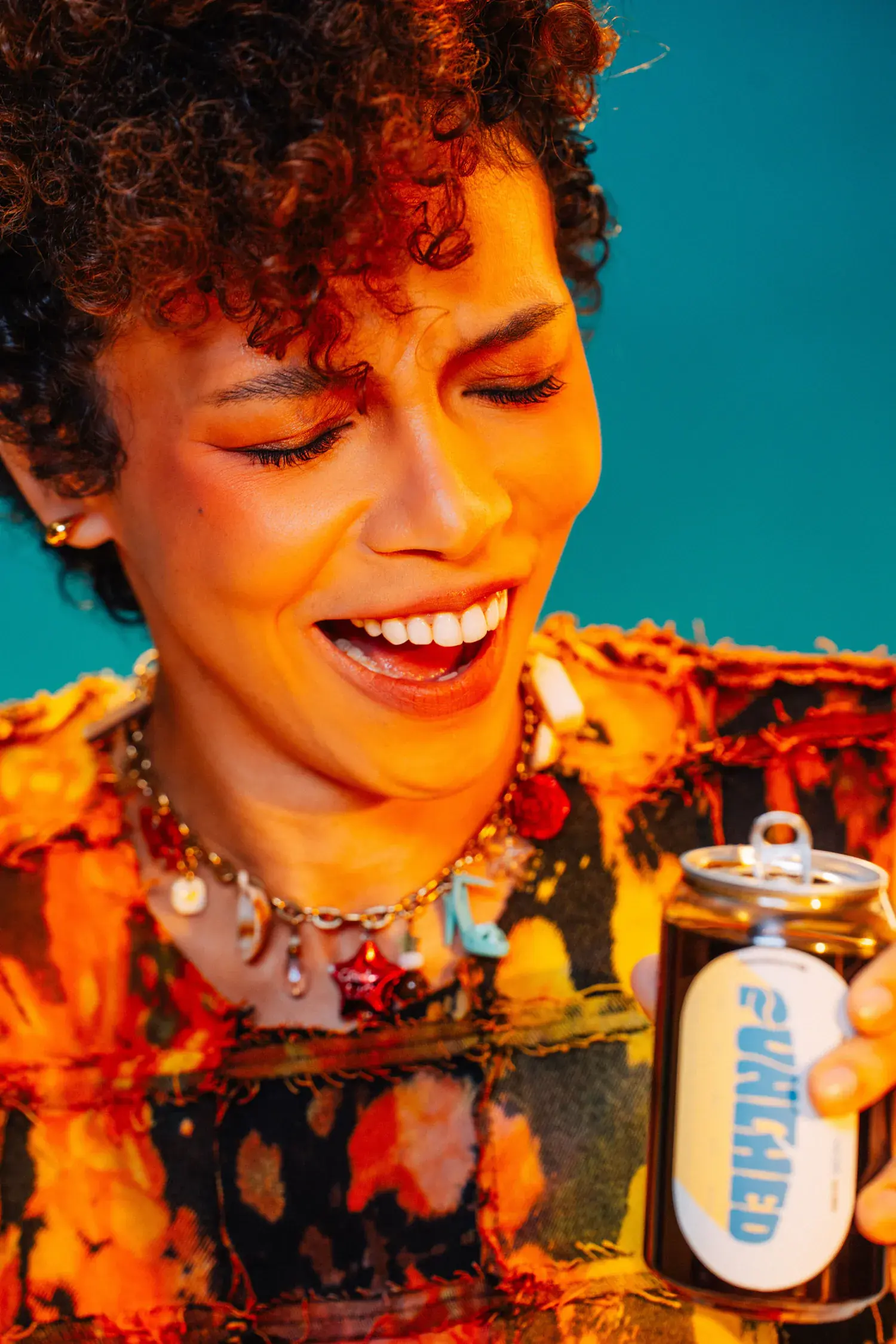 Model laughing with two Punched cans